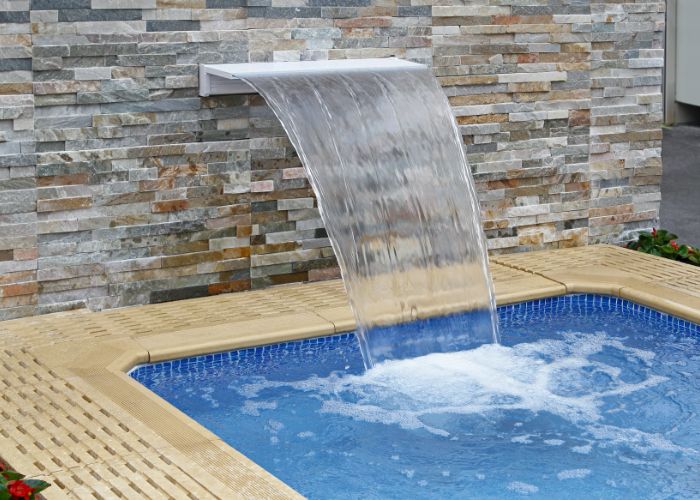 a built-in pool with fountain
